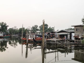 Boats moored in lake against sky