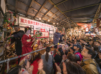 Group of people standing in street market