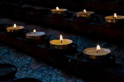 Lit tea candles in temple