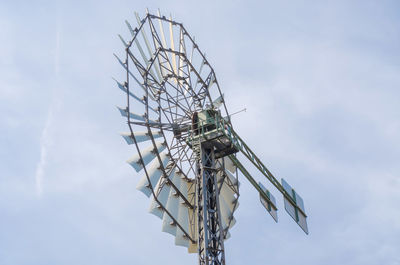 Low angle view of american-style windmill against sky