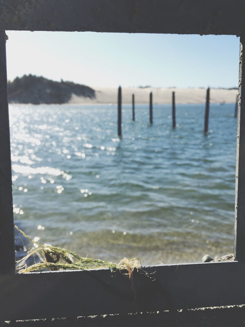 water, sea, transfer print, auto post production filter, tranquility, tranquil scene, beach, nature, scenics, horizon over water, beauty in nature, shore, day, sky, no people, outdoors, clear sky, wood - material, idyllic, close-up