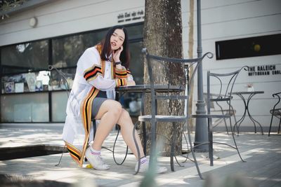 Full length of woman sitting on chair