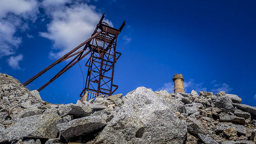 Low angle view of tower against blue sky