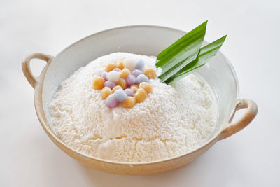 High angle view of dessert in bowl against white background