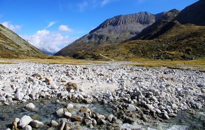 Scenic view of sea and mountains against sky