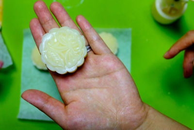 Young woman holding hands over white background