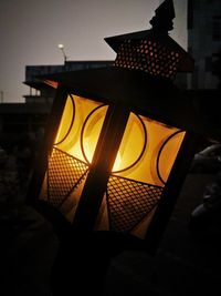 Low angle view of illuminated lamp at night