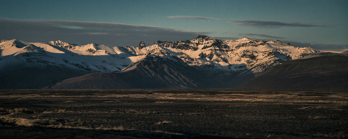 Scenic view of snowcapped mountains against sky