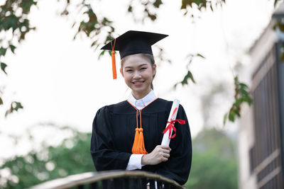 Portrait of a smiling young woman holding umbrella