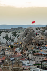 Aerial view of townscape and mountain against sky