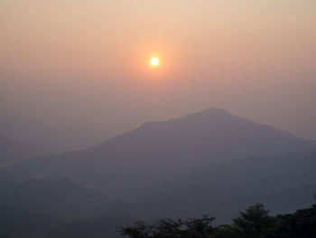 Scenic view of silhouette mountains against sky during sunset