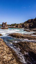 Scenic view of sea against clear blue sky