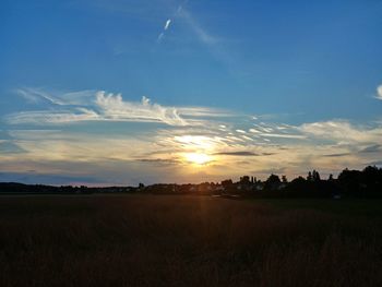 Scenic view of field against sky during sunset