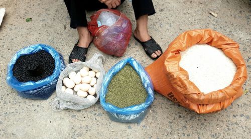 Low section of man standing by basket at market stall