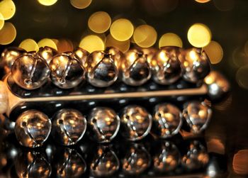 Close-up of christmas hand bells music instrument with golden blurred light background 