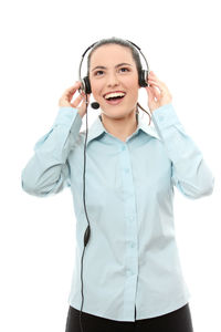 Smiling young woman using smart phone against white background