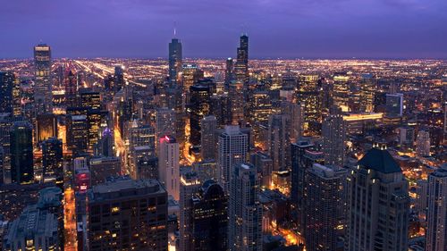 Aerial view of city lit up at night