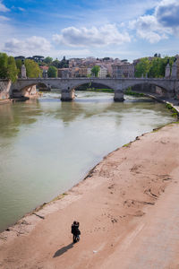 High angle view of couple standing by river in city