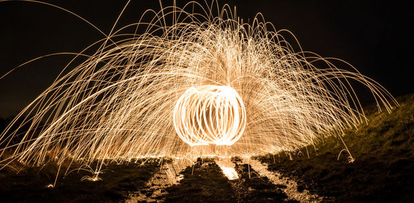 Wire wool against sky at night