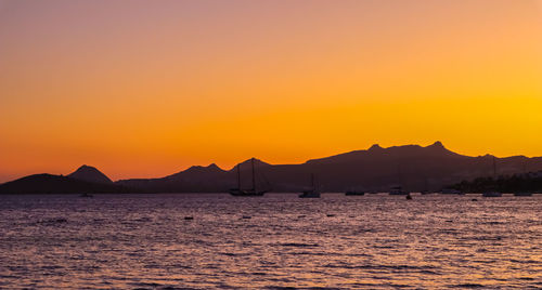 Scenic view of sea against orange sky