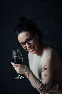 Portrait of smiling young woman holding drink