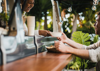 Smiling chef serving food to customer