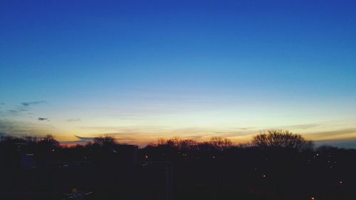 Silhouette of trees against sky at sunset