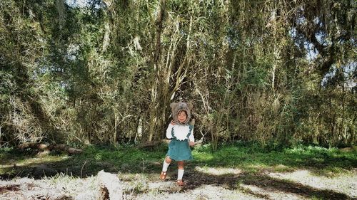 Full length portrait of girl standing on field