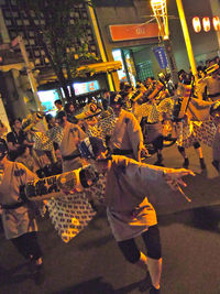 High angle view of people on street in city at night