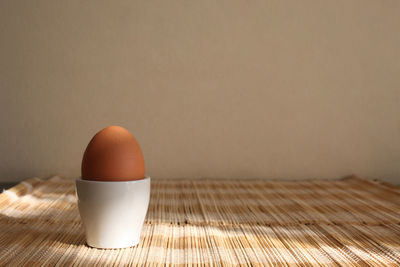 Close-up of breakfast on table against wall