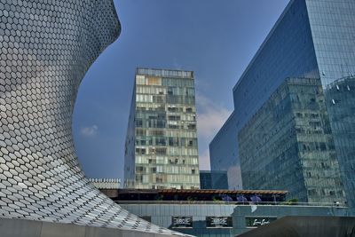 Low angle view of modern buildings against sky