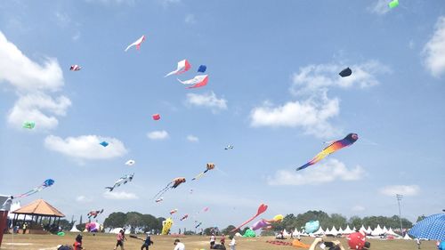 Low angle view of people flying in sky