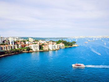 High angle view of cityscape by sea against sky