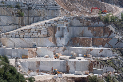 View of the carrara marble quarries and the transport trails carved into the side of the mountain.