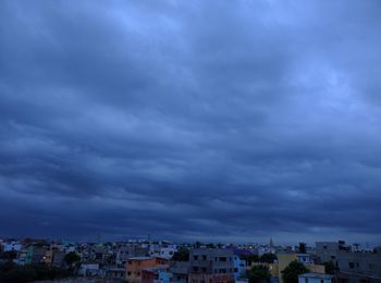 Buildings against cloudy sky