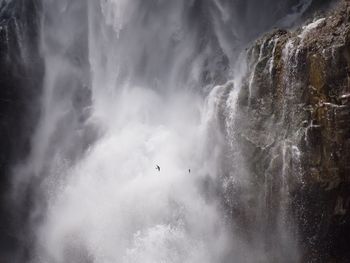 Scenic view of waterfall against sky