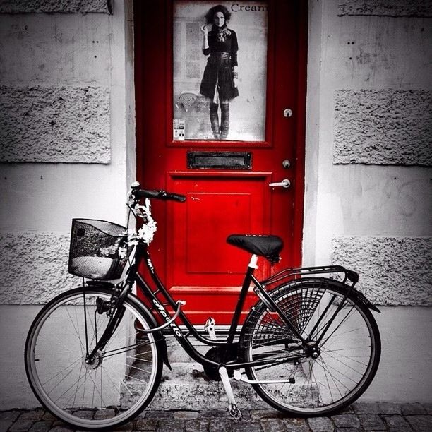 bicycle, mode of transport, transportation, land vehicle, stationary, parking, architecture, building exterior, built structure, parked, door, wall - building feature, leaning, wall, day, red, outdoors, no people, travel, house