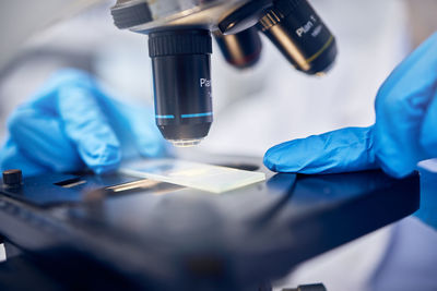 Midsection of scientist examining chemical in laboratory