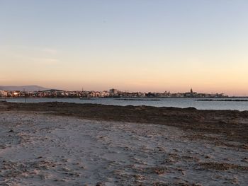 Scenic view of beach against sky during sunset