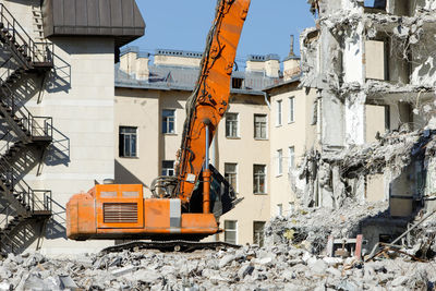 Construction site by buildings in city