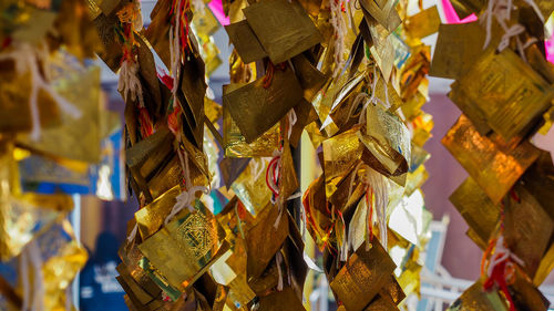 Close-up of multi colored umbrellas hanging outside temple