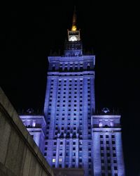 Low angle view of illuminated buildings against sky at night