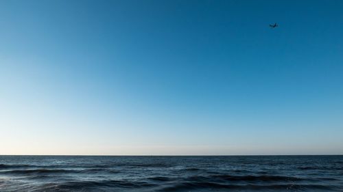 Scenic view of sea against clear blue sky