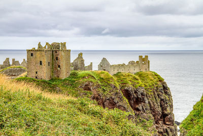 Castle by sea against sky