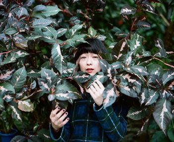 Portrait of a girl standing against plants