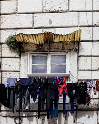 Low angle view of clothes drying against building