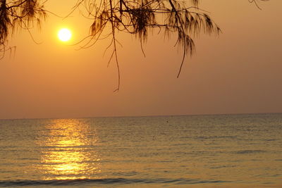 Scenic view of sea against orange sky