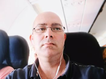 Man looking away while traveling in airplane