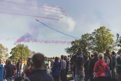 People at music concert against sky