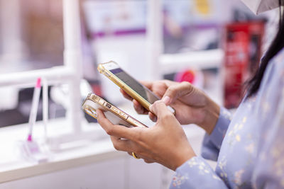 Midsection of woman using mobile phone